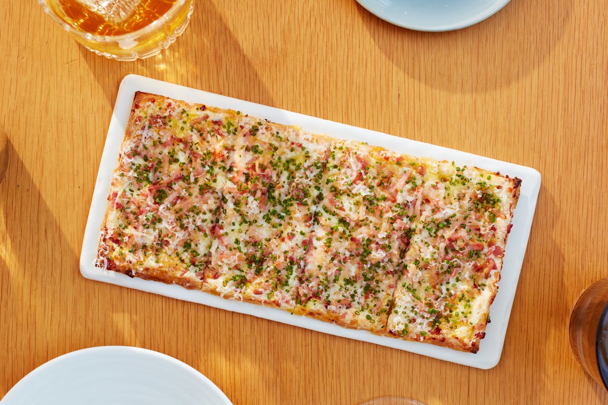 a slice of pizza sitting on top of a wooden table