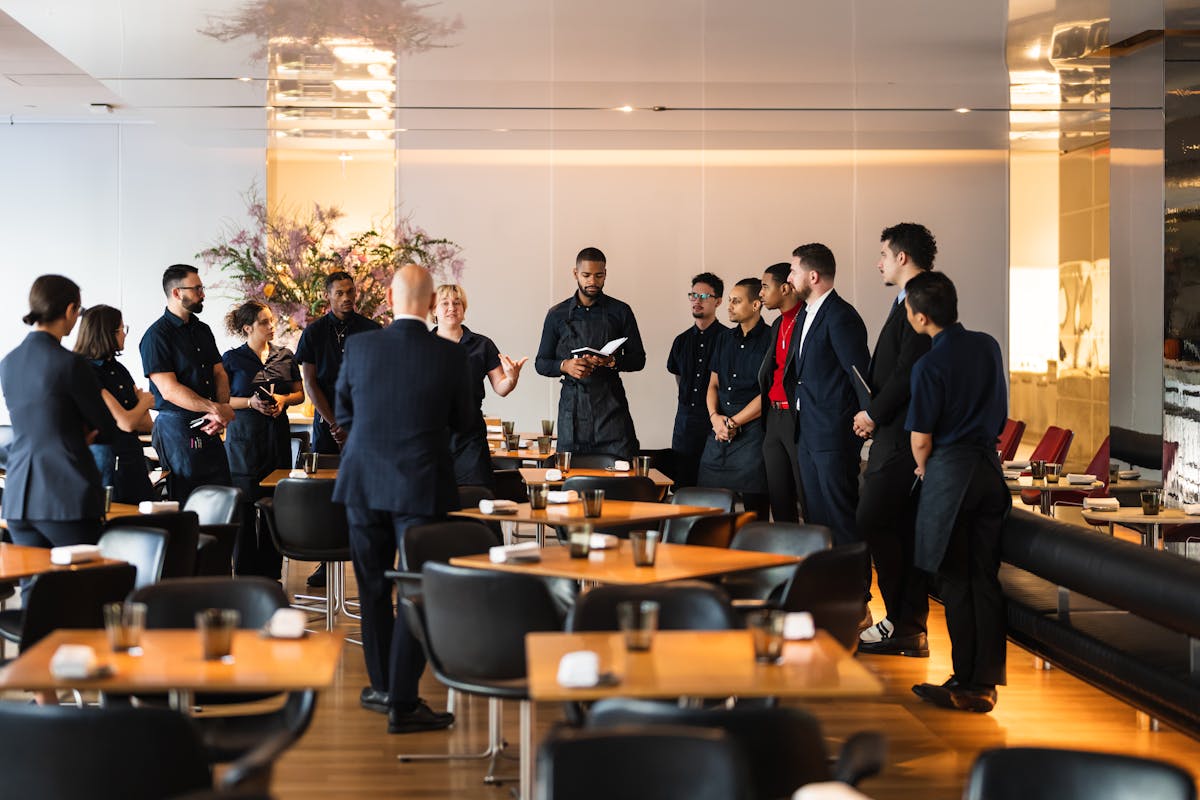 a group of people standing around a table